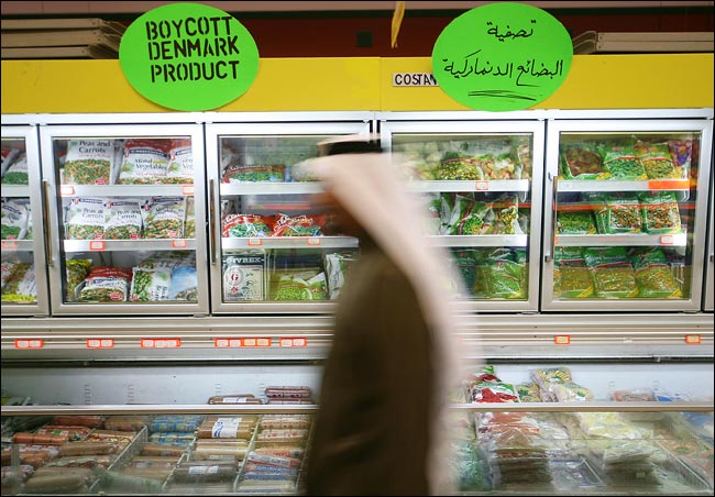 A shopper passes signs calling for the boycott of Danish products inside a supermarket in protest of Cartoons of Muhammad that originated in Denmark and offended many Muslims, Manama, Bahrain, February 2, 2006.